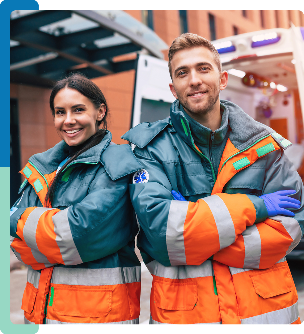 Two people in orange and blue jackets standing next to each other.